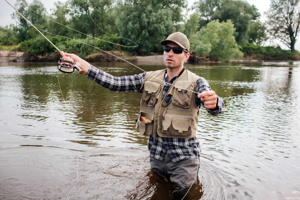 man wearing fly fishing vest
