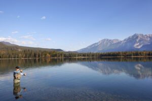 Fly Fishing Lakes - A man fly fishing on a lake