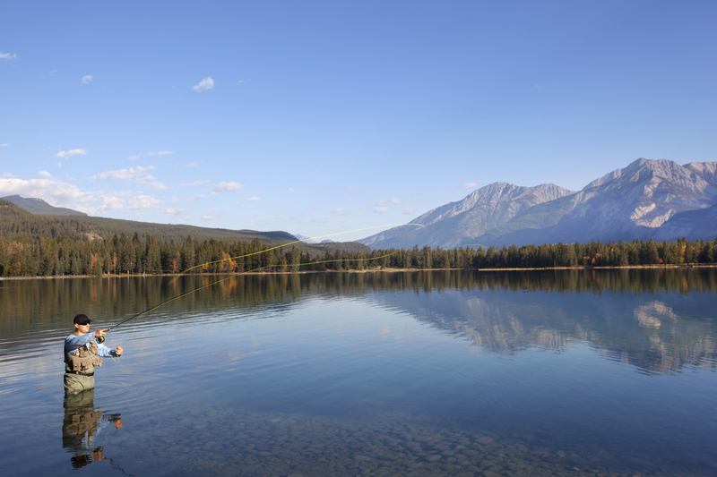 Fly Fishing Lakes - A man fly fishing on a lake